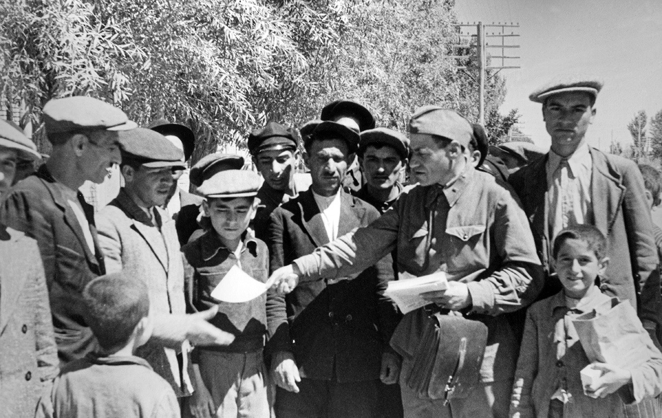 Soviet Army political instructor hands out propaganda leaflets to Tabriz residents. August 1941.