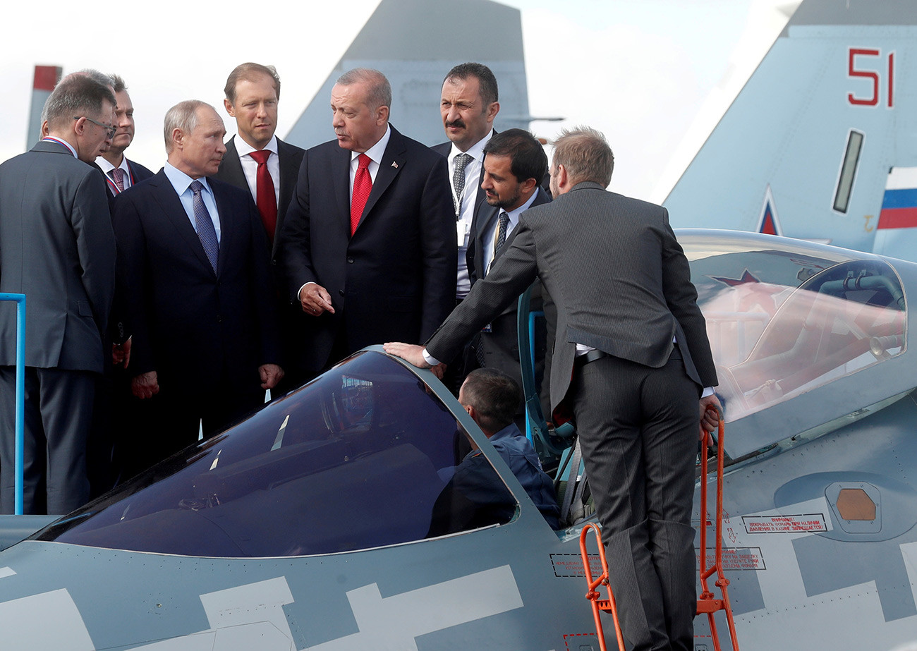 Russian President Vladimir Putin, Russian Industry and Trade Minister Denis Manturov and Turkish President Recep Tayyip Erdogan inspect a Sukhoi Su-57 fifth-generation fighter during the MAKS-2019 International Aviation and Space Salon in Zhukovsky outside Moscow.