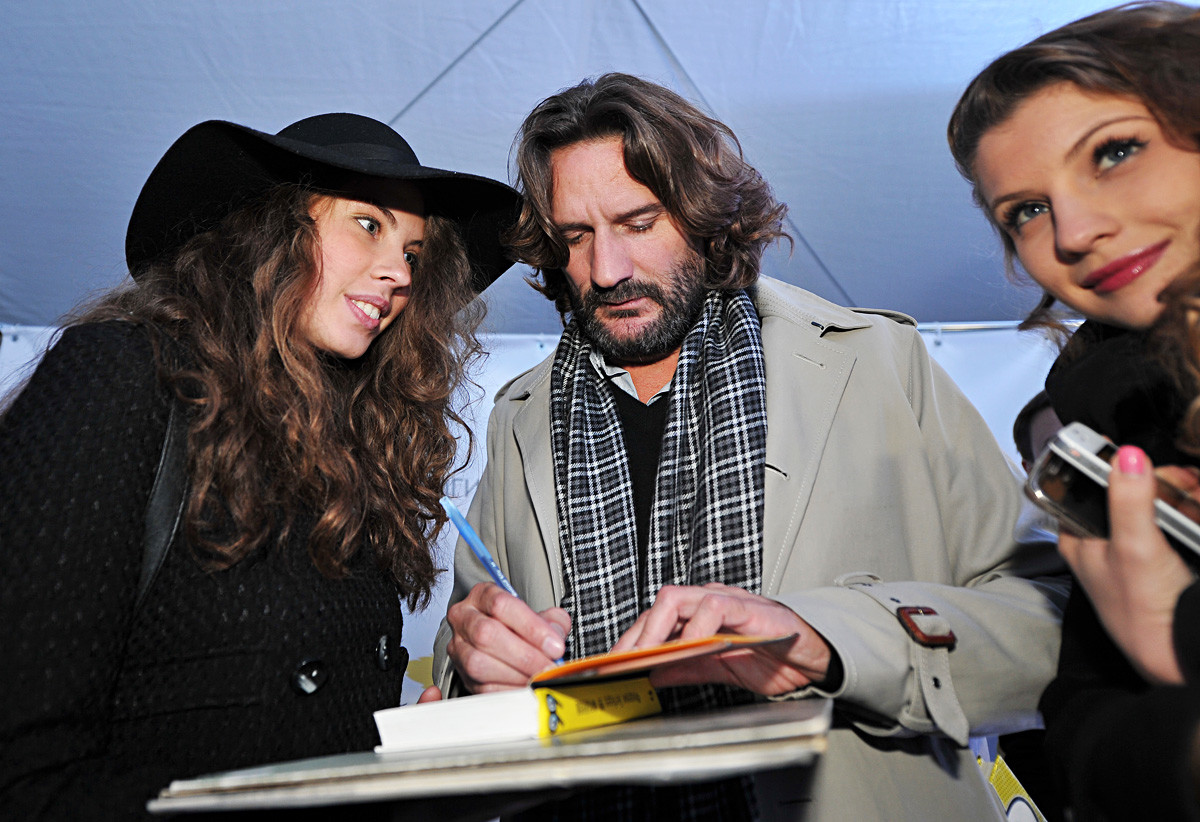 French author Frédéric Beigbeder gives autographs at the BookMarket festival