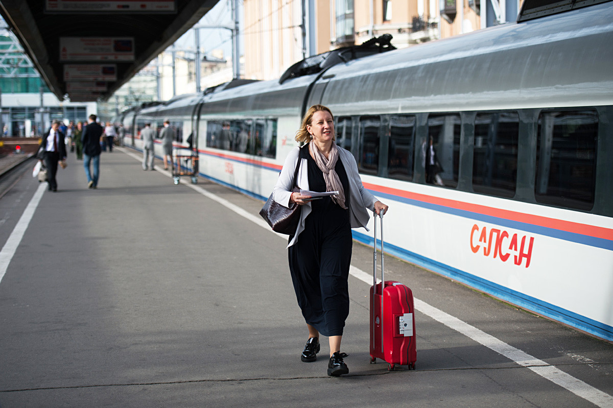Passengers on St. Petersburg's Moscow Railway Station platform by the Sapsan high-speed train on the St.Petersburg-Moscow line