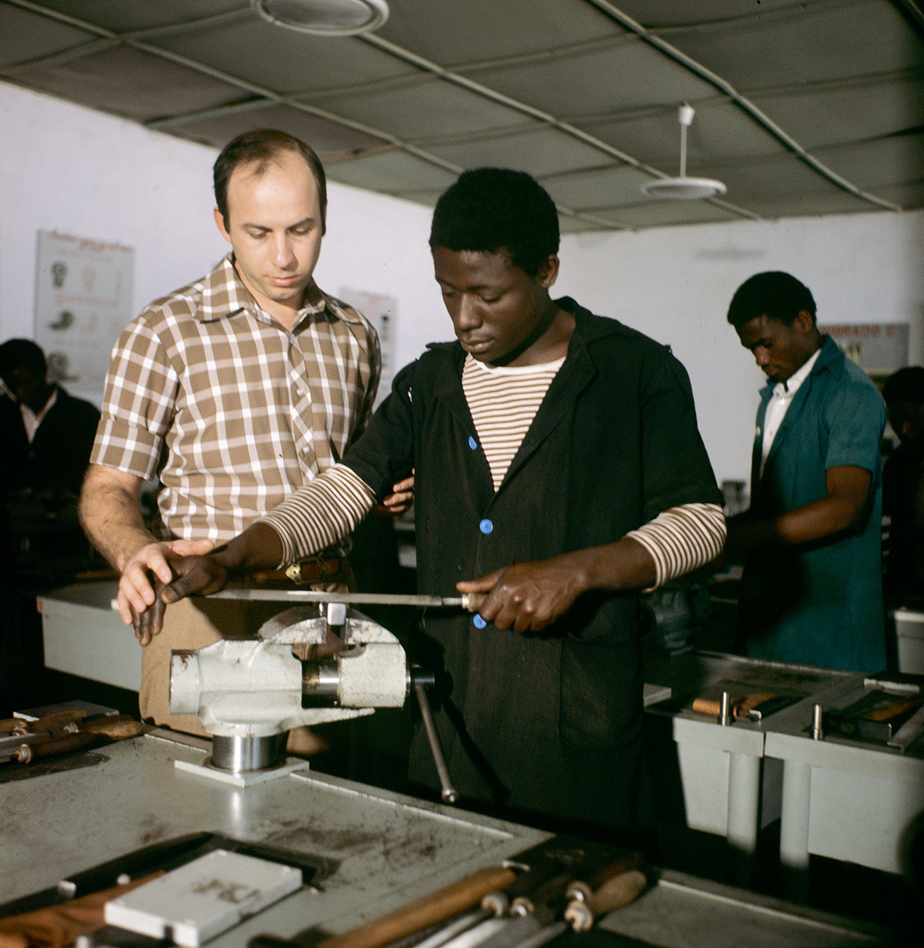 A Soviet locksmith teaching an African student.