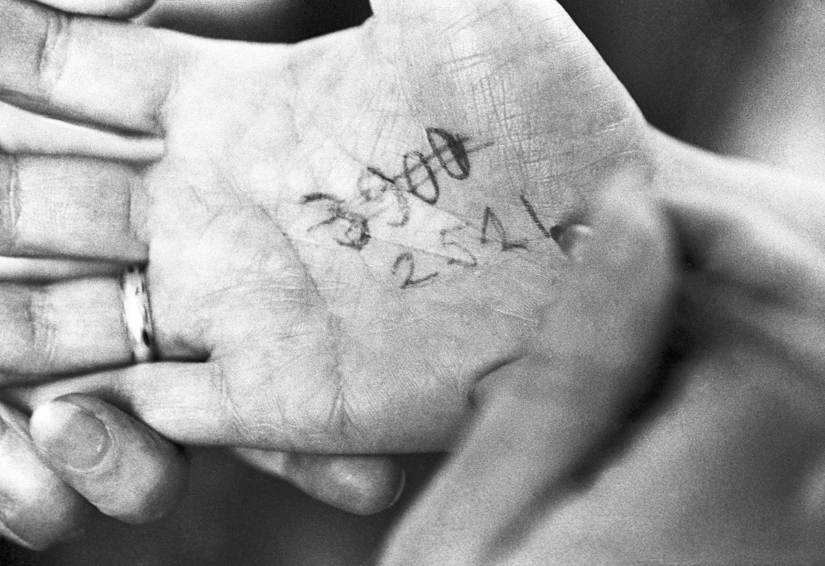 A queue number on the palm of someone’s hand.
