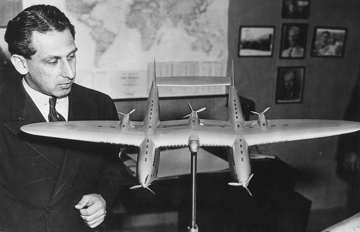 Alexander Prokofiev de Seversky with a model of a twin-fuselage aircraft, circa 1935.