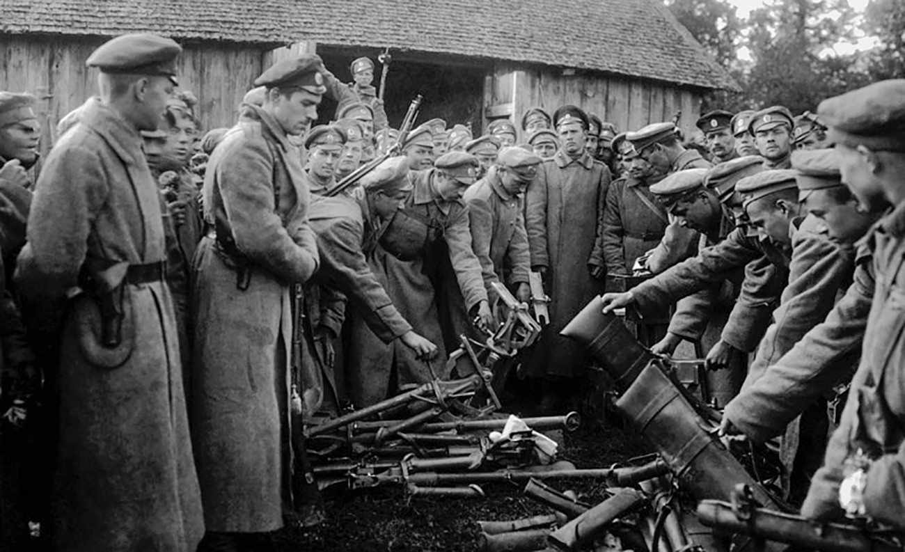 The White Army soldiers surrendering their weapons. 