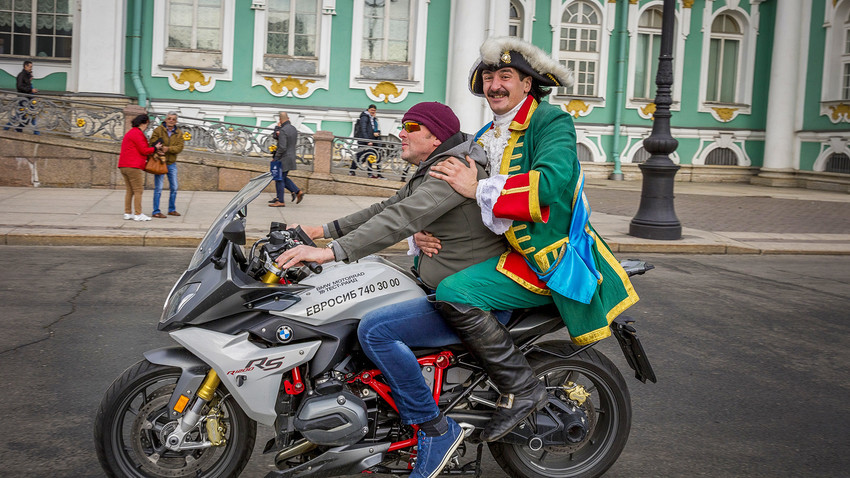 Pedro el Grande en la plaza del Palacio con un turista holandés. San Petersburgo.