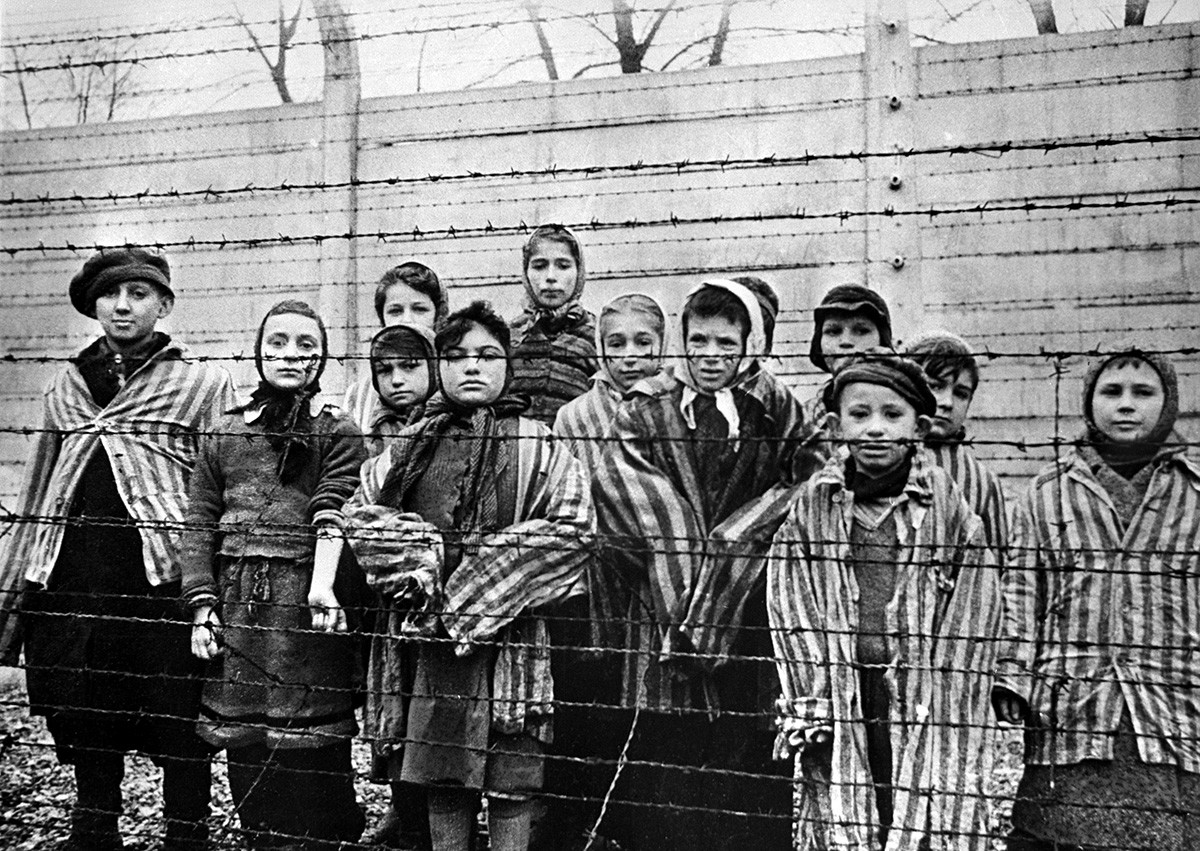 Children behind the wire in the Auschwitz concentration camp