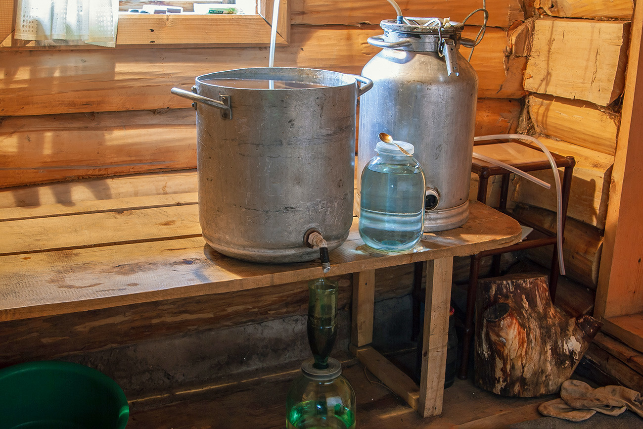 The Russian rustic way of producing alcohol in a country bath.