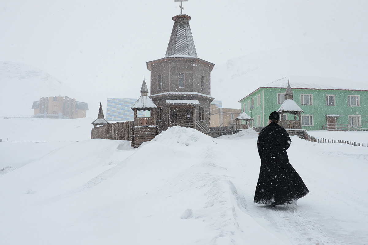 A priest near a church in the town of Barentsburg on the Spitsbergen archipelago.