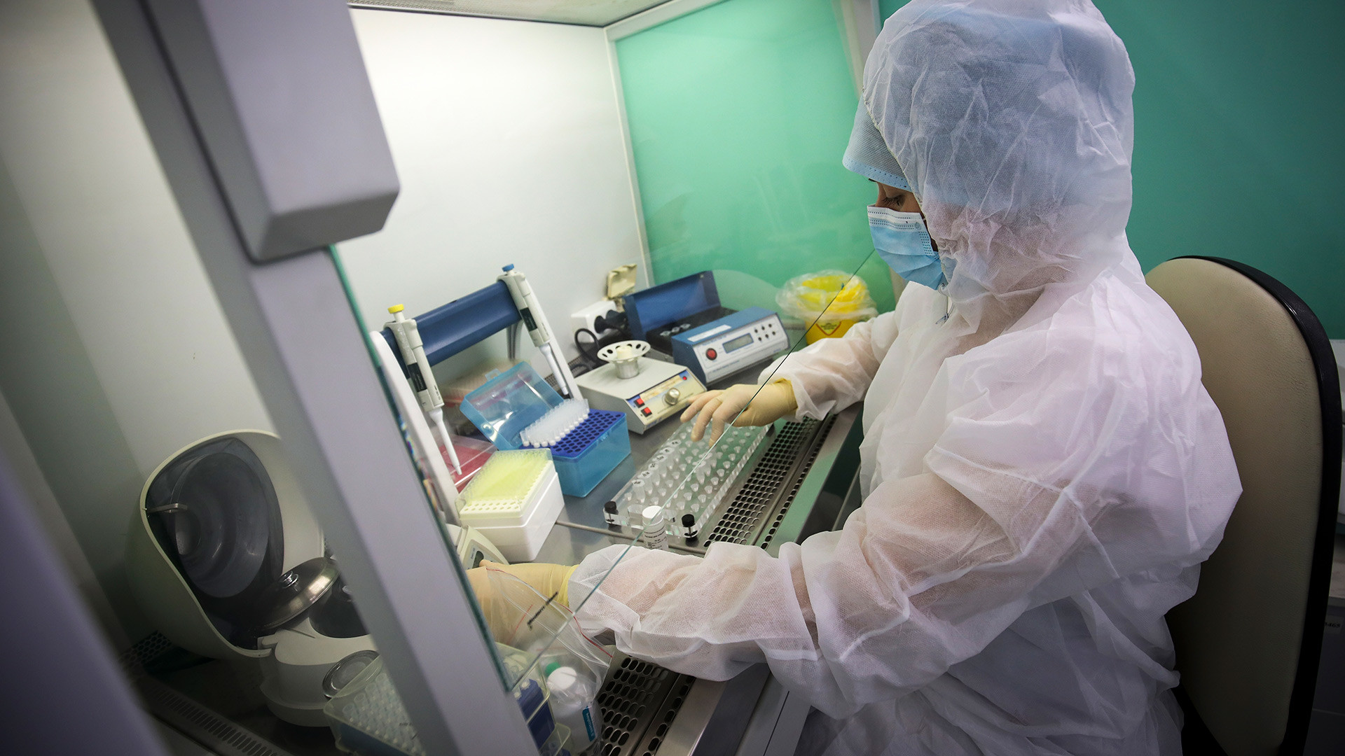 A medical staffer works with test systems for the diagnosis of coronavirus, at the Krasnodar Center for Hygiene and Epidemiology microbiology lab in Krasnodar, Russia