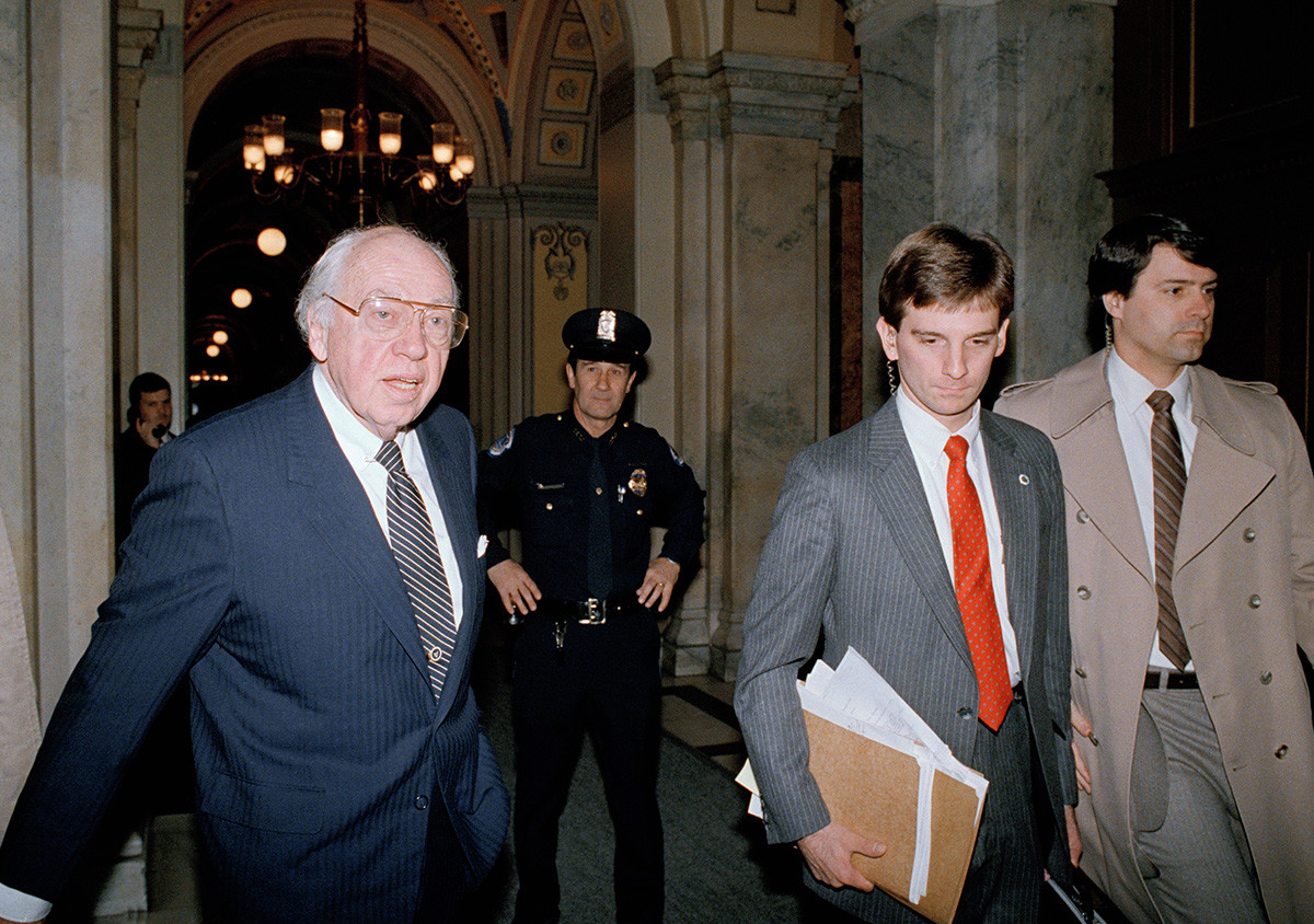 CIA Director William Casey walks past a Capitol Hill policeman on Friday, Nov. 21, 1986.