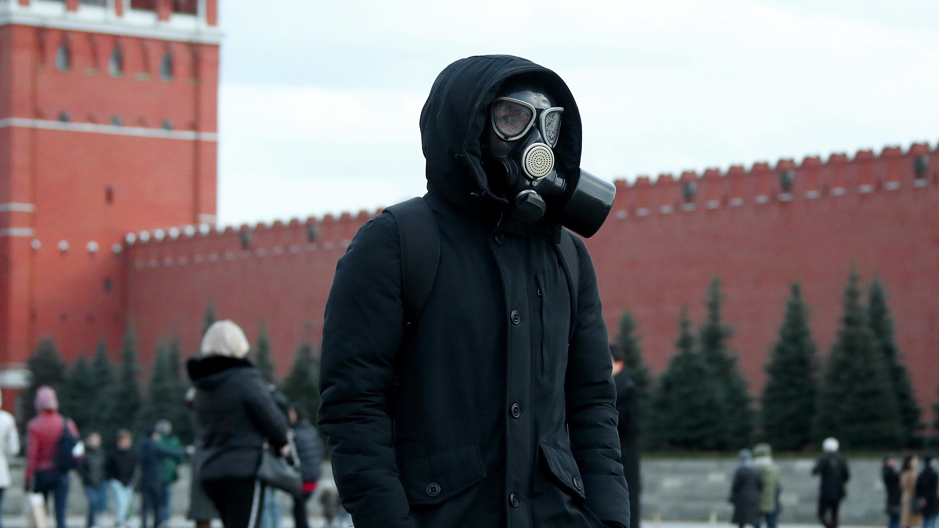 A man in a gas mask walks on Red Square