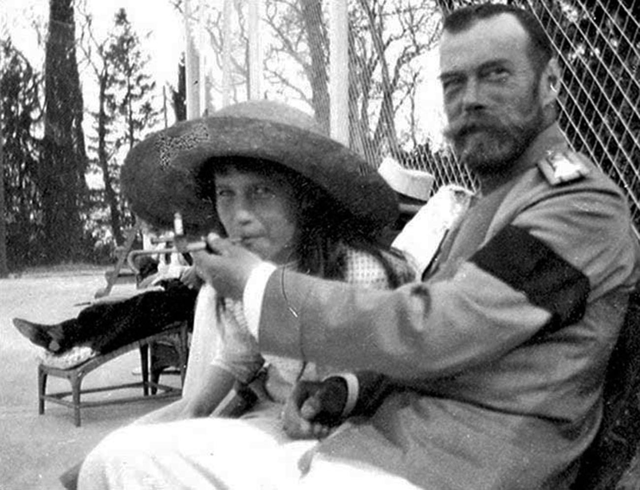 Nicholas II offers Anastasia a drag from his mouthpiece that holds a cigarette.  