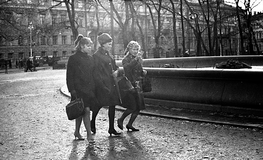 Tiga perempuan berjalan di taman.