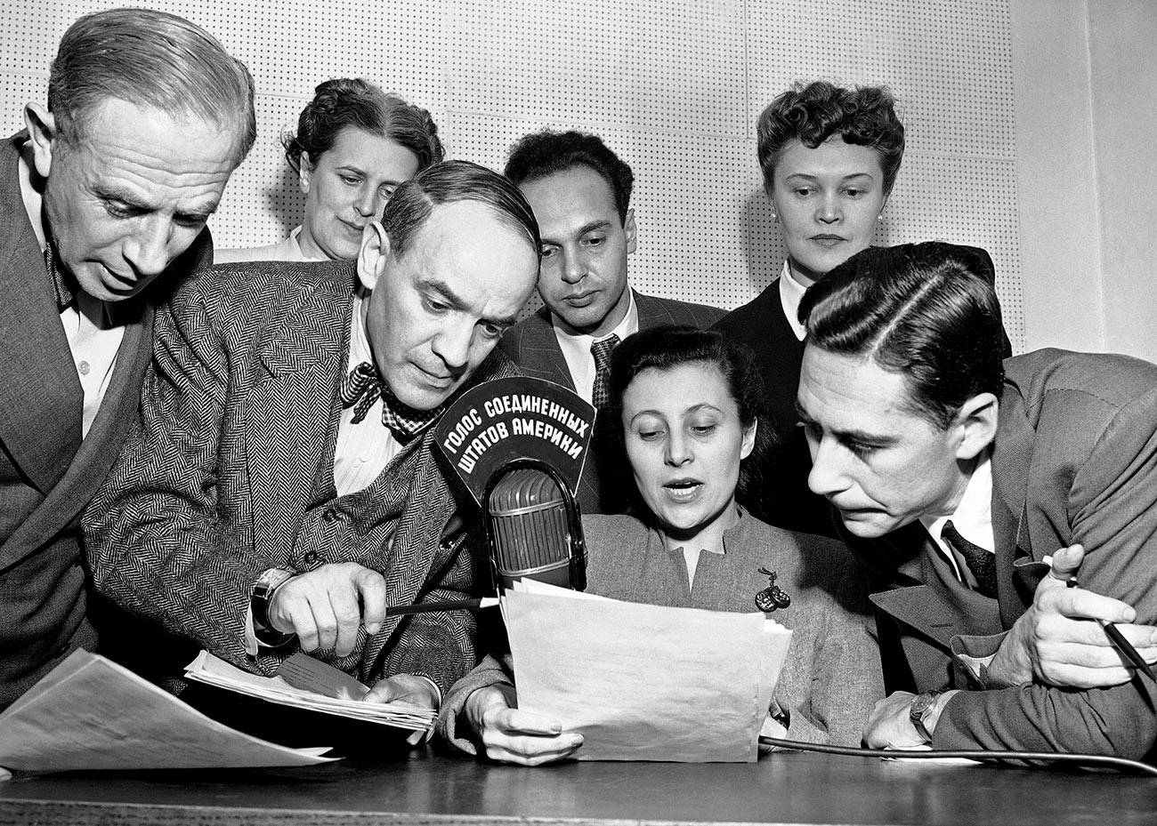  A group of State Department announcers huddle around the microphone after the initial shortwave broadcast in Russian to Russia from New York City on Feb. 17, 1947.
