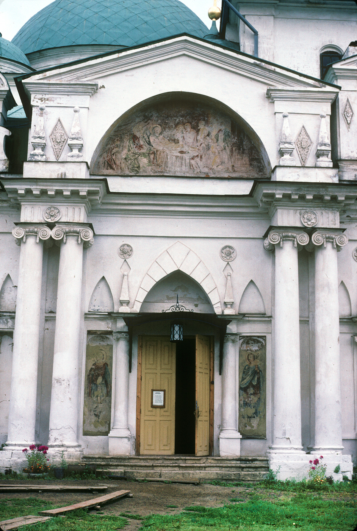 Church of St. Yakov. West view with main entrance. Painting of Nativity of the Virgin on tympanum of narthex pediment. August 5, 1995 