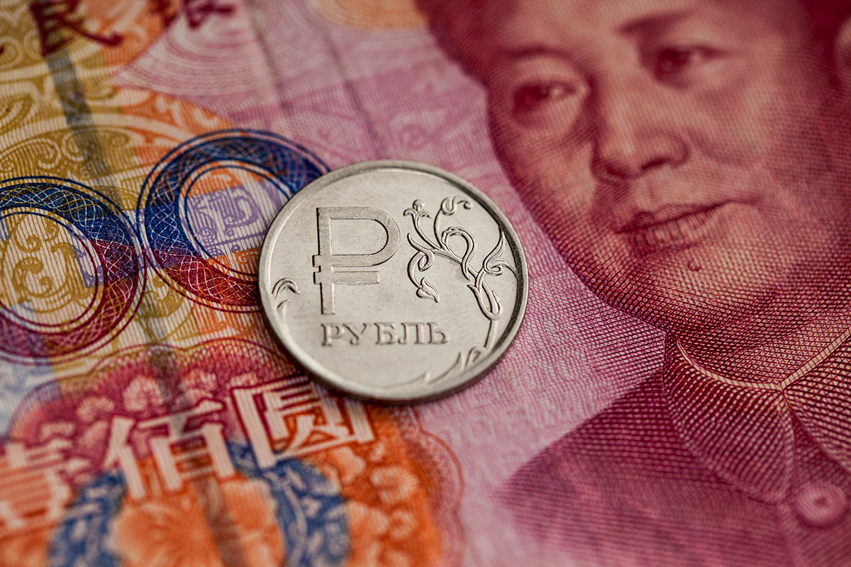 Kurs rublja u odnosu na juan. U krupnom planu je prikazana novčanica od jednog rublja i sto kineskih juana.
