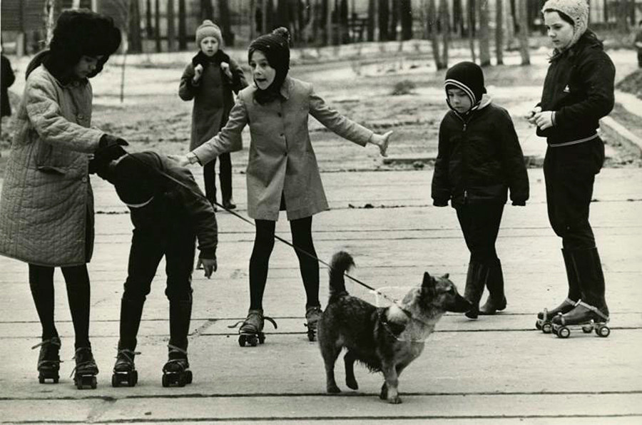 Children walking a dog.