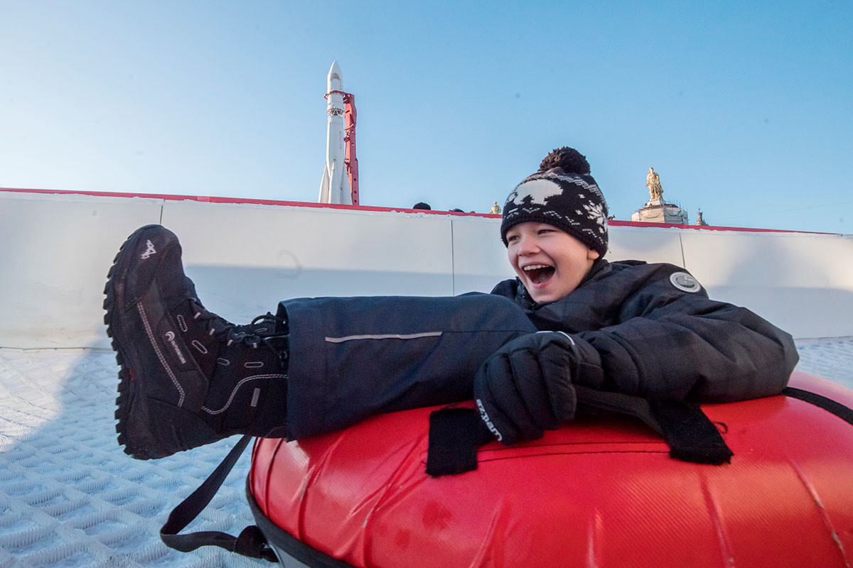 A kid riding tubing at VDNKh Soviet-era park in Moscow