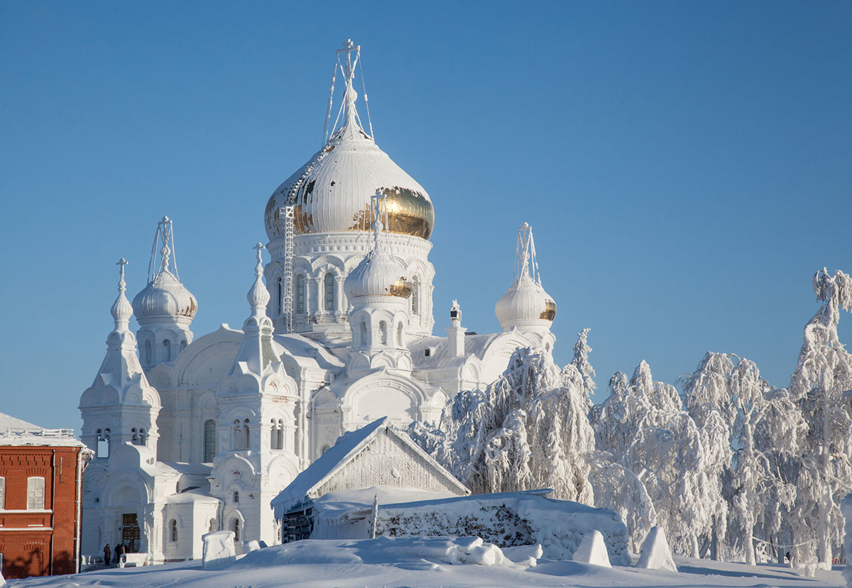 Two Russian women in winter clothes against Orthodox monastery