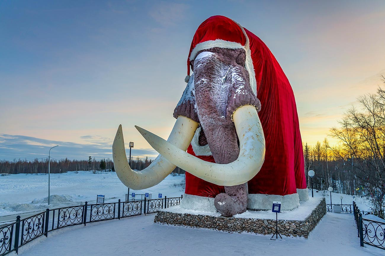 Mitya the mammoth wearing Santa's coat.