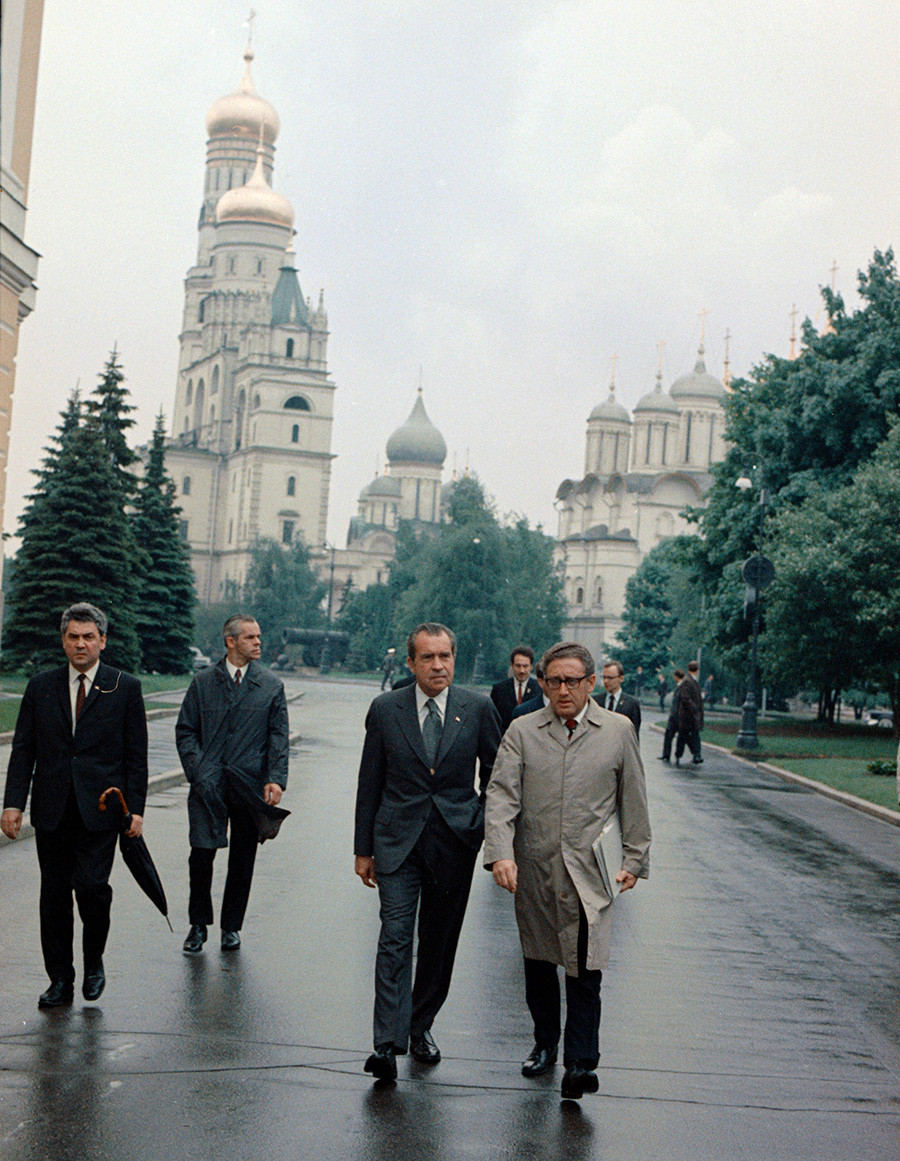 President Richard Nixon, center, walks with National Security Adviser Henry Kissinger, right, inside the Kremlin, May 29, 1972
