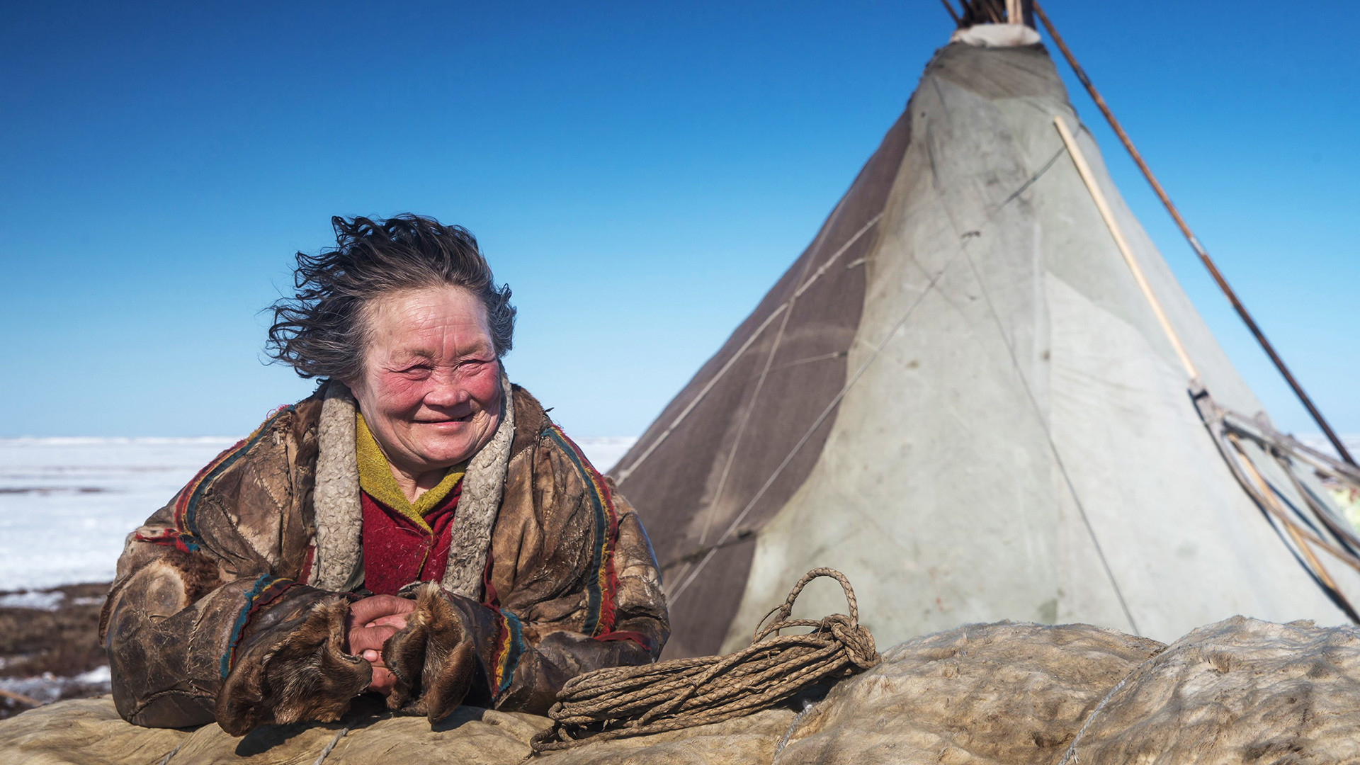 A reindeer herder women looks on at a nomad camp at 150 km from the town of Salekhard, Yamalo-Nenets Autonomous Okrug, May 2, 2016. 