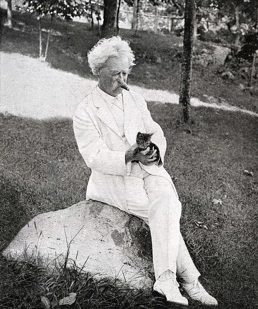 Mark Twain smoking and holding a kitten