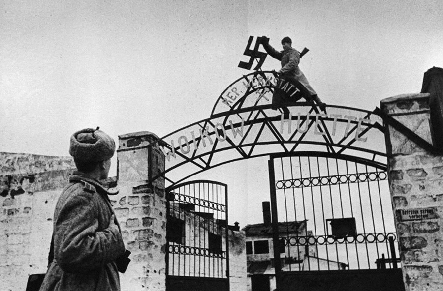Des soldats soviétiques arrachent la croix gammée des portes de l'usine Voïkov à Kertch, en Crimée, 1944