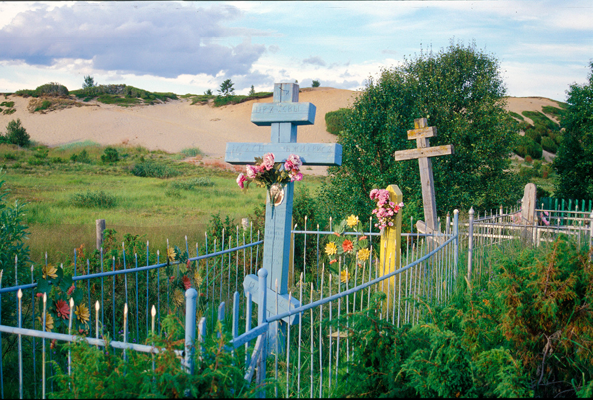 Varzuga cemetery on left bank. Background: sand dunes with juniper bushes.  July 21, 2001