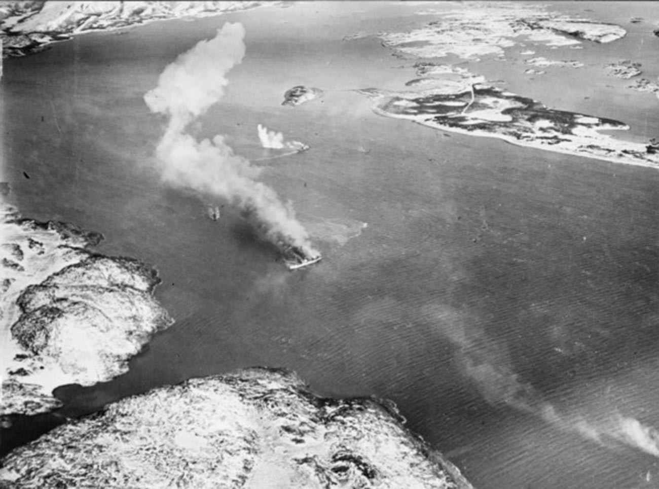 Теретни брод „Ригел“ који је био у служби немачке армије и патролни чамци из његове пратње у пламену после бомбардовања.