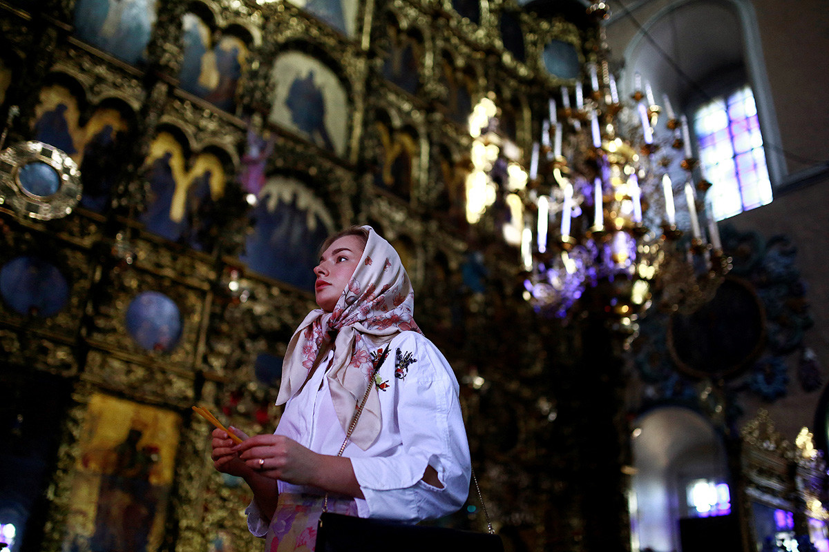 A woman gives a prayer in the Saint Peter and Saint Paul church in Kazan