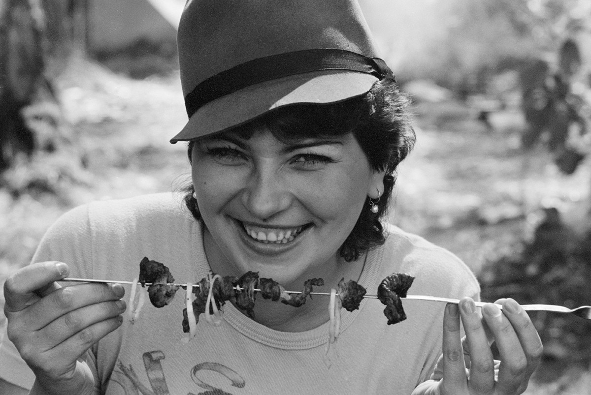 Muscovite Vera Sherbakova eating some shashlik, 1985.