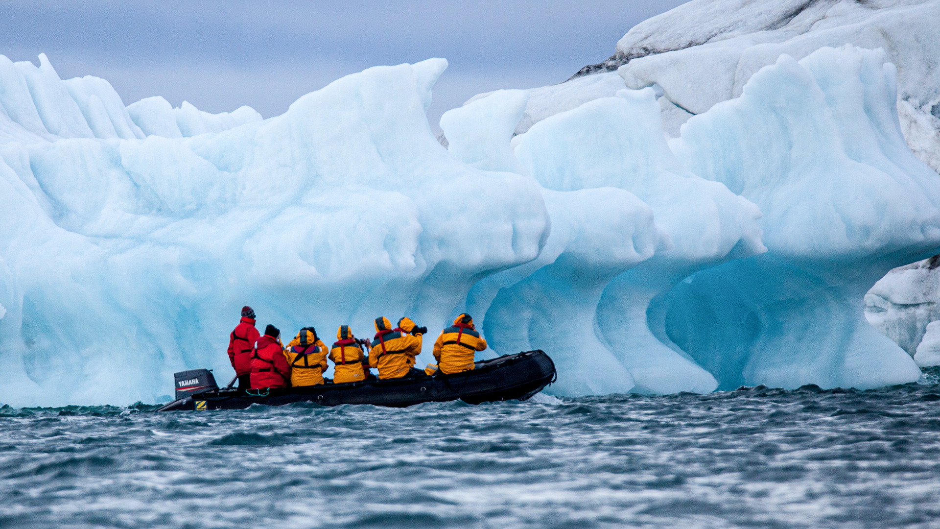 'Zodiak' with tourists in front of an iceberg in the Arctic Ocean. Russian Arctic.