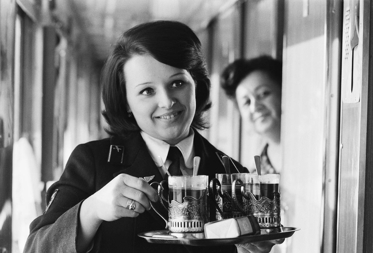 A train conductor serving tea