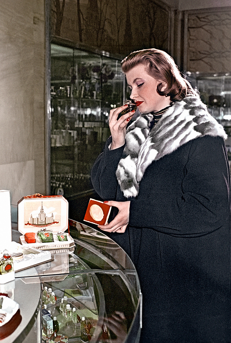 A customer at the counter of a perfume store in Okhotny Ryad chooses perfume. 1958