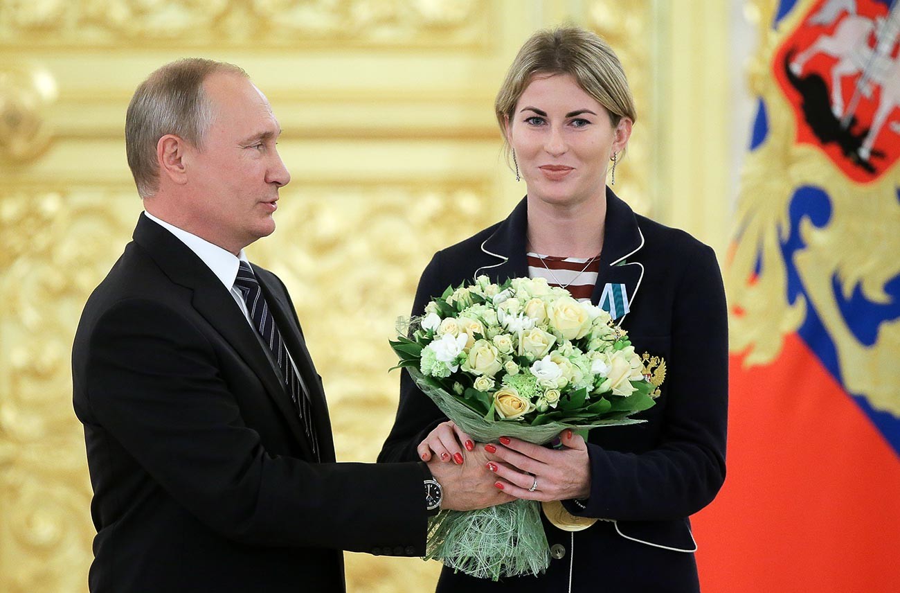 Russian President Vladimir Putin and Olympic saber fencing champion Inna Deriglazova, recipient of the Order of Friendship, at the awarding ceremony for members of the Russian Olympic team - winners and medalists of the 2016 Rio de Janeiro Olympics in the Kremlin