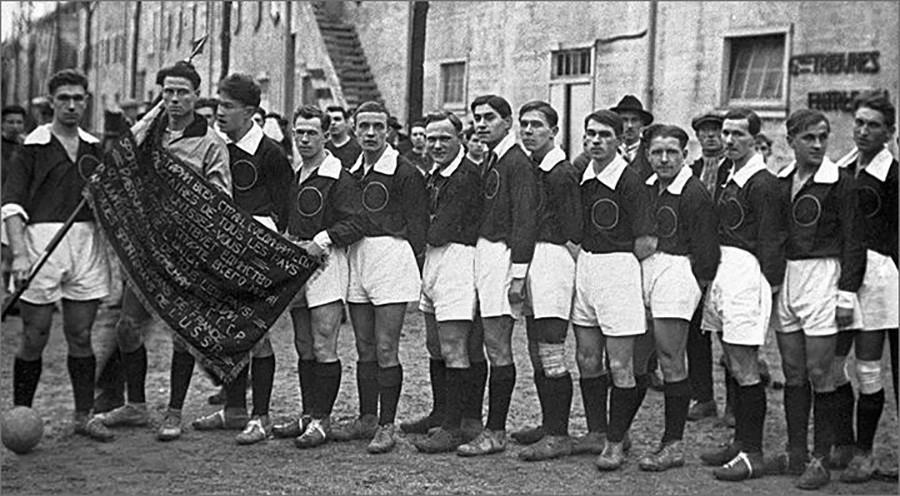 Pemain sepak bola Soviet di Paris, 1926. Artemyev memegang bendera Soviet.