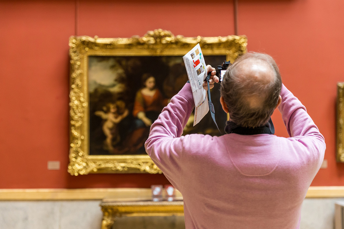 A visitor taking photos at the Hermitage museum