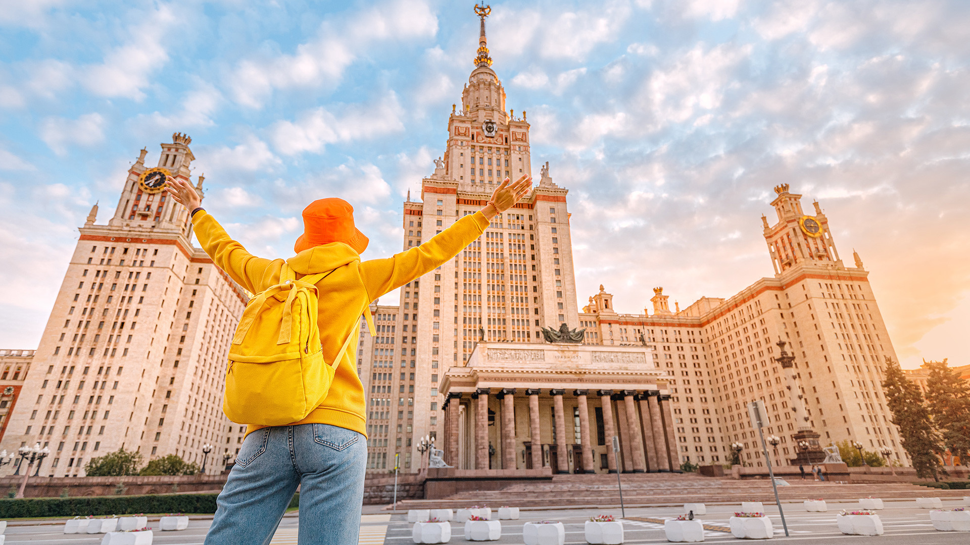 A young student rejoices of the beginning of the school year in front of the main building of Lomonosov Moscow State University