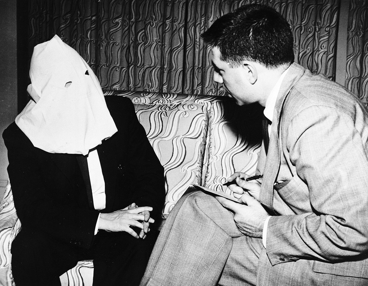 Igor Gouzenko, former Russian cypher clerk who revealed a Soviet spy ring in Canada in 1945, wears a hood to conceal his face, during a n interview with Associated Press writer Saul Pett, in Canada, on April 29, 1954.