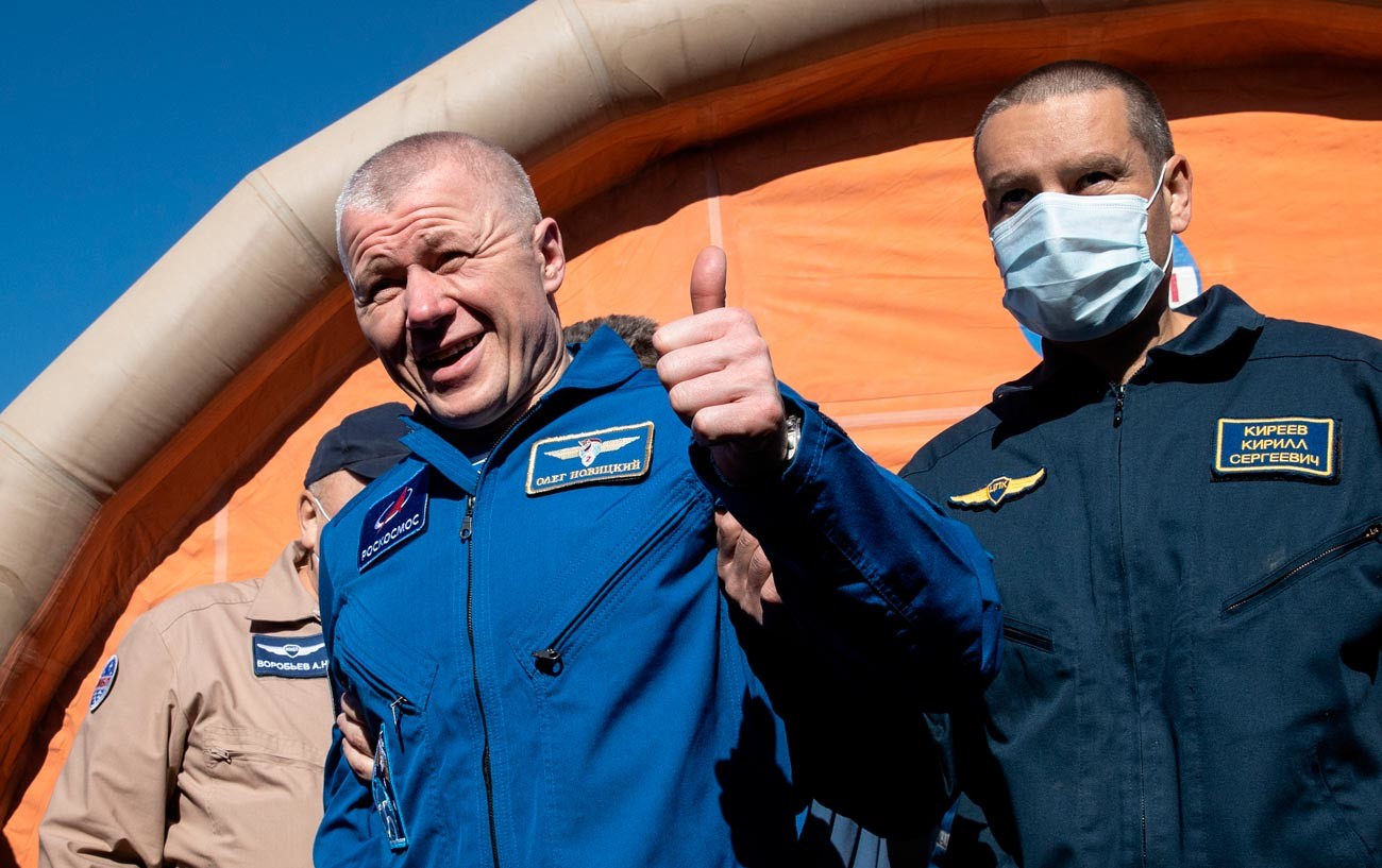 Cosmonaut Oleg Novitsky (left) after landing the descent vehicle of the Soyuz MS-18 transport manned spacecraft