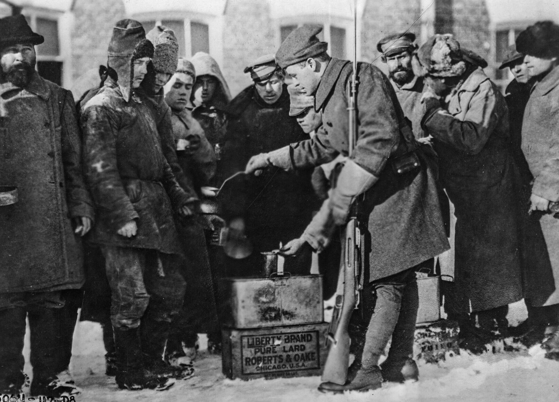 Bolshevik prisoners are fed rice by a U.S. soldier in January 1919.