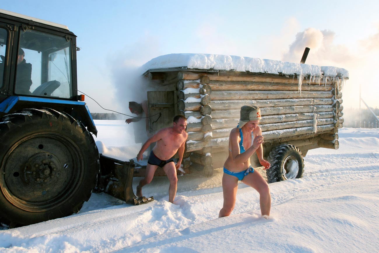 Im Dorf Bobrowka, etwa 400 km nördlich der sibirischen Stadt Omsk, rennen Menschen aus den mobilen russischen Bädern in den Schnee.