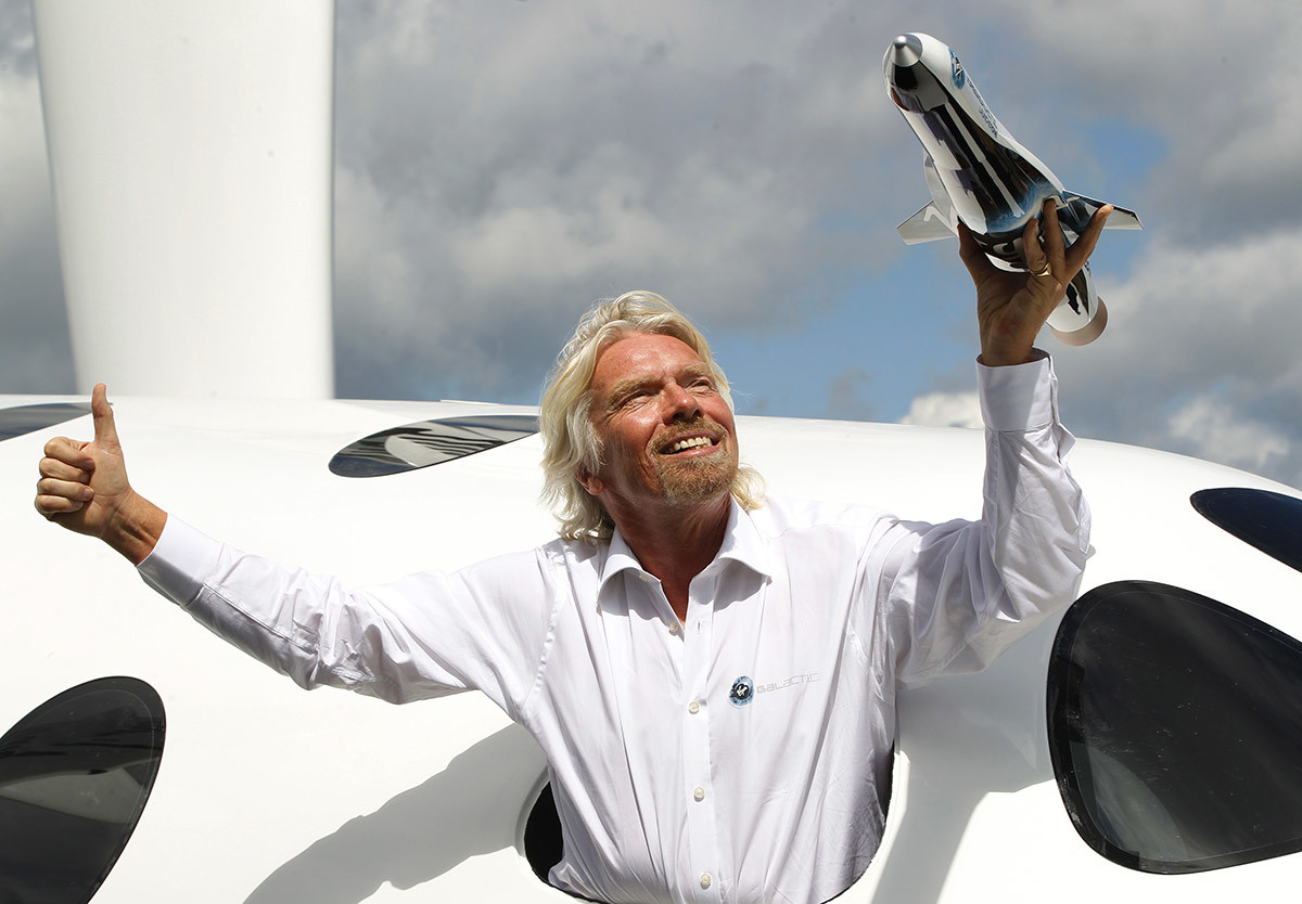 Sir Richard Branson poses for the photographers in the window of a replica of the Virgin Galactic, which according to the company will be the world’s first commercial spaceline. 