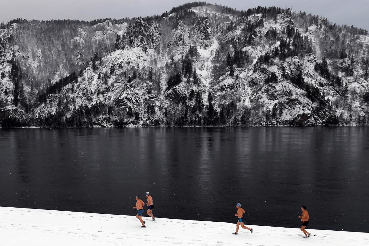 Members of winter swimming club run across the Yenisei River 