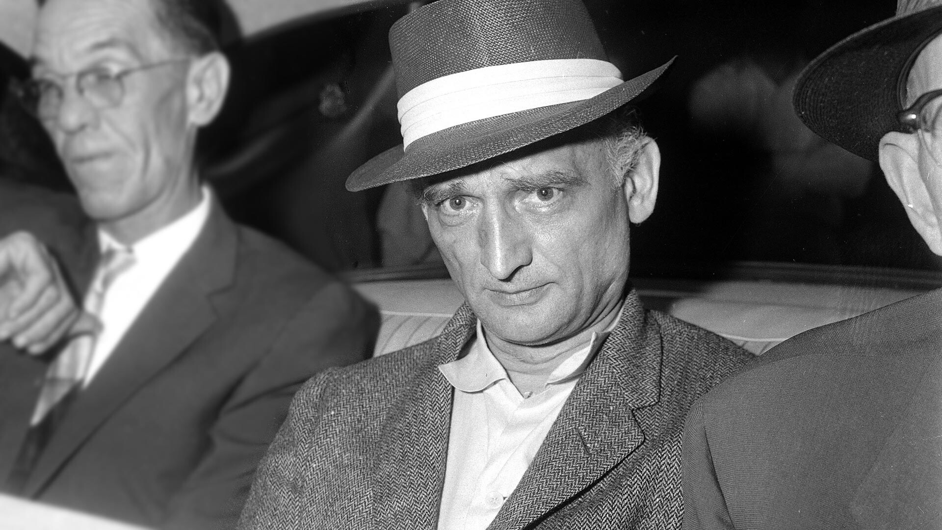 Rudolf Abel, 55, accused Russian master spy, is wide-eyed and close-mouthed as he arrives in New York City from Texas, Aug. 8, 1957. 