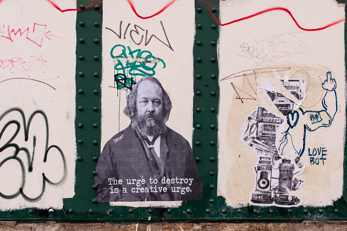 Sticker on a wall representing Bakunin and the quote 