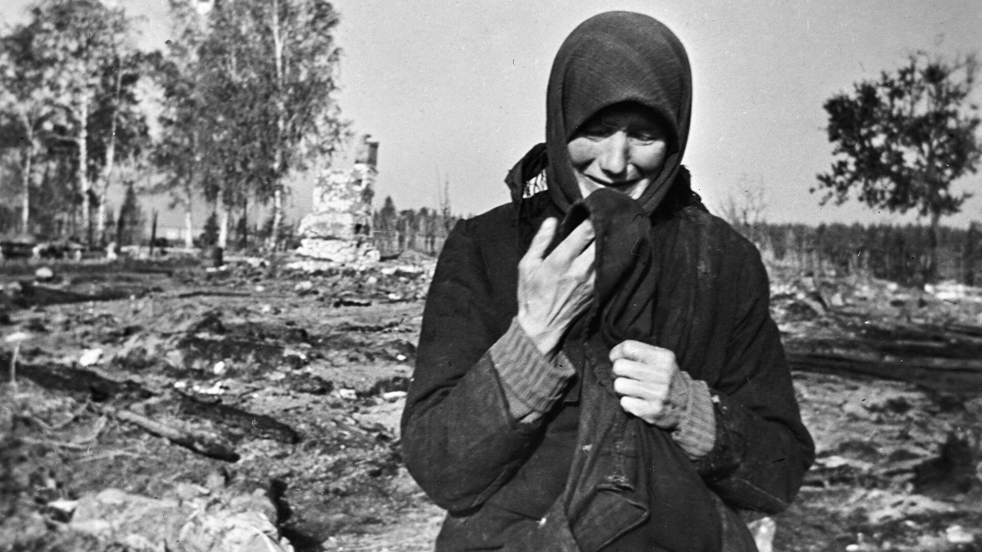 Woman weeping on the ruins of her native village burnt by the Nazis.