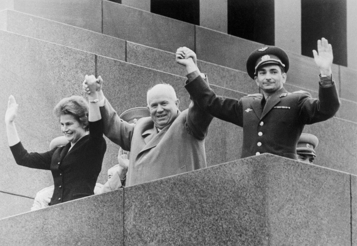 Holding hands of Soviet Premier Nikita Khrushchev (center), Russia's 