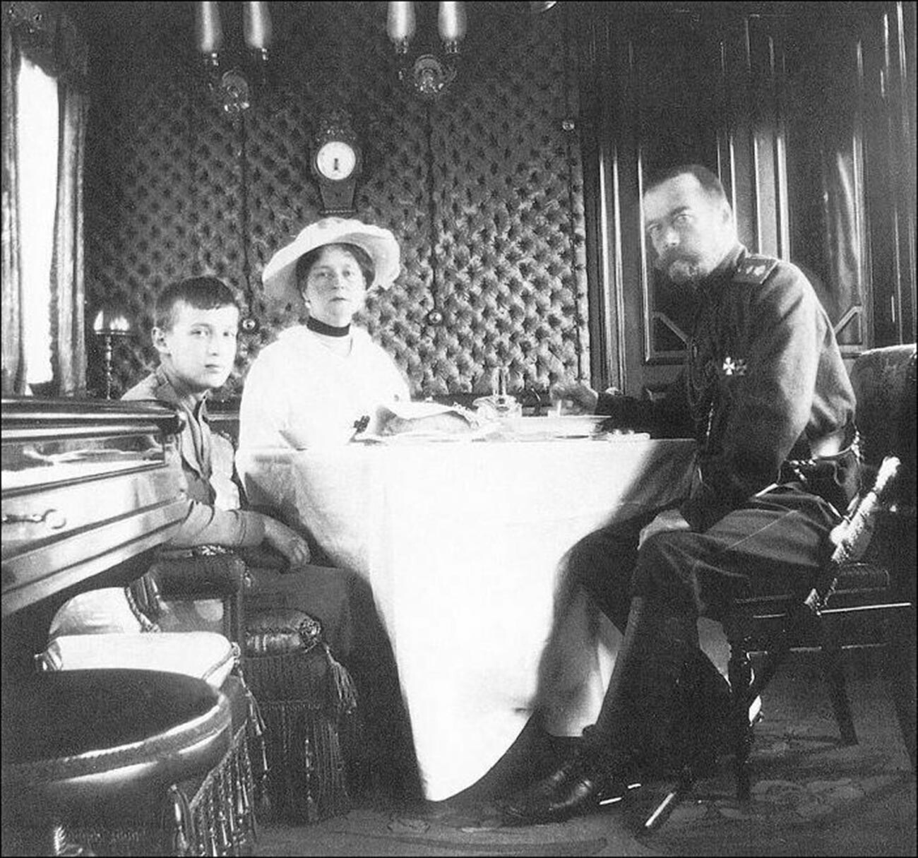 Nikolaus II. mit seiner Frau, Kaiserin Alexandra, und seinem Sohn, Prinz Alexei, im Zug.